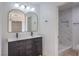 Bright bathroom with a dual sink vanity, modern fixtures, and a marble tiled walk-in shower at 5203 Treasure Ave, Las Vegas, NV 89122