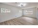Bright bedroom with hardwood floors and plenty of natural light from three windows at 5203 Treasure Ave, Las Vegas, NV 89122