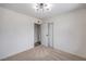A cozy bedroom with plush carpet, modern lighting, and a convenient closet space at 5203 Treasure Ave, Las Vegas, NV 89122