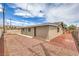 Exterior showcasing rock landscaping, fenced yard, and neutral colors at 5203 Treasure Ave, Las Vegas, NV 89122