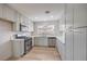 Modern kitchen featuring stainless steel appliances, white cabinets, and light countertops at 5203 Treasure Ave, Las Vegas, NV 89122