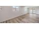 Spacious living area with wood-look flooring, large windows, and access to the backyard at 5203 Treasure Ave, Las Vegas, NV 89122