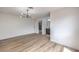 A bright main bedroom features wood-look floors, modern lighting, and an en-suite bathroom at 5203 Treasure Ave, Las Vegas, NV 89122