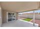 Covered patio offers shade and access to a cleanly landscaped backyard with privacy wall at 5203 Treasure Ave, Las Vegas, NV 89122