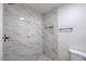 Elegant shower featuring marble-style tile, a rainfall showerhead, and a built-in niche at 5203 Treasure Ave, Las Vegas, NV 89122