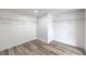 A well-organized walk-in closet with built-in shelving and wood-look flooring at 5203 Treasure Ave, Las Vegas, NV 89122
