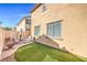 Great backyard for entertaining: a covered patio, seating, and artificial turf at 5232 Pendergrass St, North Las Vegas, NV 89081
