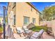 Cozy backyard featuring outdoor seating, patio, artificial turf, and stucco wall at 5232 Pendergrass St, North Las Vegas, NV 89081