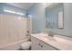 Bright bathroom with a bathtub and shower combo, vanity and a modern mirror at 5232 Pendergrass St, North Las Vegas, NV 89081