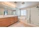 Bright bathroom with a double vanity, soaking tub, and a glass-enclosed shower at 5232 Pendergrass St, North Las Vegas, NV 89081