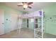 Bright bedroom featuring carpet, a lofted bed with desk, ceiling fan, closet and shelves at 5232 Pendergrass St, North Las Vegas, NV 89081