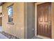 Close-up view of front door with sidelight and well-maintained exterior at 5232 Pendergrass St, North Las Vegas, NV 89081