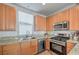 Bright kitchen with stainless steel appliances, sink, and wooden cabinets at 5232 Pendergrass St, North Las Vegas, NV 89081