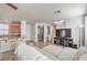 Inviting living room open to kitchen, featuring a breakfast bar and a large-screen TV at 5232 Pendergrass St, North Las Vegas, NV 89081