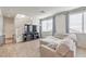 Bright living room with wood-look tile flooring and a comfortable sectional sofa near the stairs at 5232 Pendergrass St, North Las Vegas, NV 89081
