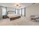 Expansive main bedroom featuring neutral tones, ample natural light, and a cozy papasan chair at 5232 Pendergrass St, North Las Vegas, NV 89081