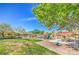 Community playground and picnic area with lush green grass, playground equipment and shaded picnic tables at 5232 Pendergrass St, North Las Vegas, NV 89081