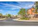 Community entrance and street view of Vista Cielo with lush landscaping and a clear blue sky at 5232 Pendergrass St, North Las Vegas, NV 89081