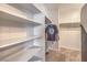 A walk-in closet with multiple shelves and a rack for hanging clothes to maximize storage space at 5232 Pendergrass St, North Las Vegas, NV 89081