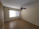 Bedroom showcasing tile flooring, a ceiling fan, and a bright window at 5710 E Tropicana Ave # 1172, Las Vegas, NV 89122