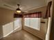 Bright bedroom with tiled floors, ceiling fan, and two windows at 5710 E Tropicana Ave # 1172, Las Vegas, NV 89122