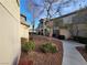 View of condo building exterior with sidewalk, trees and professional landscaping at 5710 E Tropicana Ave # 1172, Las Vegas, NV 89122