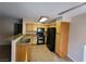 Modern kitchen with granite countertops, wooden cabinets, and black appliances at 5710 E Tropicana Ave # 1172, Las Vegas, NV 89122