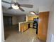 Open-concept kitchen with granite countertops, wooden cabinets, and tile flooring at 5710 E Tropicana Ave # 1172, Las Vegas, NV 89122