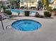 Inviting community hot tub and pool with ample seating and nearby landscaping at 5710 E Tropicana Ave # 1172, Las Vegas, NV 89122