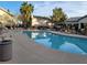 Enjoy the community pool with lounge chairs, surrounded by lush landscaping at 5710 E Tropicana Ave # 1172, Las Vegas, NV 89122