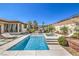 Beautiful backyard with pool, spa, pergola with outdoor kitchen, and green landscaping at 5855 Boulder Brook Ct, Las Vegas, NV 89149