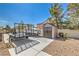 This backyard features a shed, concrete driveway, and gravel landscaping at 5855 Boulder Brook Ct, Las Vegas, NV 89149