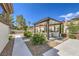 Expansive backyard with a covered outdoor kitchen, lush landscaping, and inviting patio areas at 5855 Boulder Brook Ct, Las Vegas, NV 89149