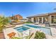 Expansive backyard oasis featuring a pool, spa, lounge area and a playground at 5855 Boulder Brook Ct, Las Vegas, NV 89149