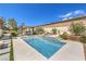 Gorgeous backyard with a pool, hot tub, built in barbecue and ample seating areas at 5855 Boulder Brook Ct, Las Vegas, NV 89149