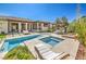 Well-appointed backyard features a pool, hot tub, dining area and mature landscaping at 5855 Boulder Brook Ct, Las Vegas, NV 89149