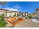 This backyard boasts a fire pit, built-in grill and play area providing ample space for outdoor enjoyment at 5855 Boulder Brook Ct, Las Vegas, NV 89149