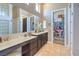 Bathroom with a large vanity, dual sinks, and a walk-in closet providing ample storage at 5855 Boulder Brook Ct, Las Vegas, NV 89149