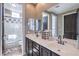 Well-lit bathroom with a double vanity, large mirror, and a shower/tub combination at 5855 Boulder Brook Ct, Las Vegas, NV 89149