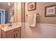 Stylish powder room boasts wainscoting, neutral walls and a framed art collection at 5855 Boulder Brook Ct, Las Vegas, NV 89149