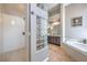 Bright bathroom showcasing a walk-in shower, soaking tub, double vanity, and stylish tile flooring at 5855 Boulder Brook Ct, Las Vegas, NV 89149