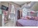 Charming bedroom with a unique canopy bed, desk, and plenty of natural light at 5855 Boulder Brook Ct, Las Vegas, NV 89149