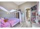 Cozy bedroom featuring a canopy bed, dresser, and a mounted TV at 5855 Boulder Brook Ct, Las Vegas, NV 89149