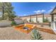 The backyard features a built-in fire pit and desert landscaping creating an outdoor oasis at 5855 Boulder Brook Ct, Las Vegas, NV 89149
