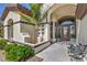Charming front entryway with stone accents, decorative plants, and an outdoor seating area at 5855 Boulder Brook Ct, Las Vegas, NV 89149