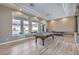 Spacious game room features an air hockey table, pool table, and scenic backyard views at 5855 Boulder Brook Ct, Las Vegas, NV 89149