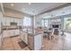 Bright kitchen offering stainless appliances and a granite island with seating that overlooks the living room at 5855 Boulder Brook Ct, Las Vegas, NV 89149