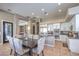 Bright, modern kitchen with white cabinets, stainless appliances, and adjacent dining area at 5855 Boulder Brook Ct, Las Vegas, NV 89149