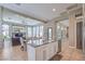 Open kitchen layout with a central island, stainless steel appliances, and view into living room at 5855 Boulder Brook Ct, Las Vegas, NV 89149