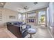 Well-lit living room showcasing a sectional couch, a built-in media center, and large windows at 5855 Boulder Brook Ct, Las Vegas, NV 89149